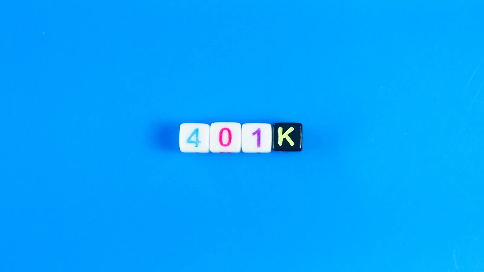 Letter tiles spelling 401K on a bright blue background.